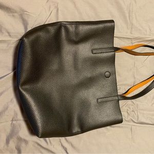 Black purse with a metallic clasp.